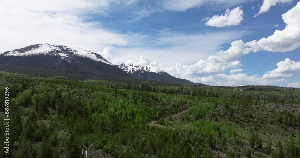 wide aerial panning shot revealing mountains in the background
