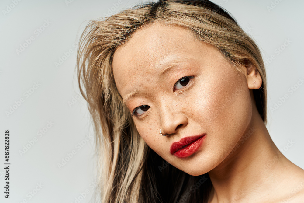 An attractive Asian woman with long hair and red lipstick striking a pose. An attractive Asian woman with long hair and red lipstick striking a pose.