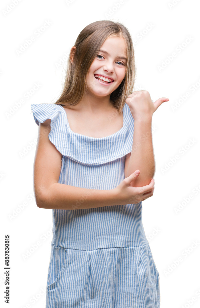Young beautiful girl over isolated background smiling with happy face looking and pointing to the side with thumb up. Young beautiful girl over isolated background smiling with happy face looking and pointing to the side with thumb up.