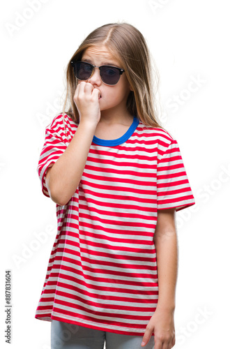 Young beautiful girl wearing sunglasses over isolated background looking stressed and nervous with hands on mouth biting nails. Anxiety problem.