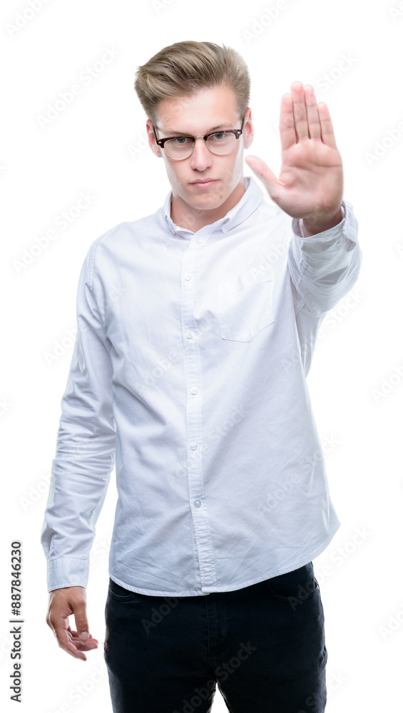 Young handsome blond man doing stop sing with palm of the hand. Warning expression with negative and serious gesture on the face. Young handsome blond man doing stop sing with palm of the hand. Warning expression with negative and serious gesture on the face.