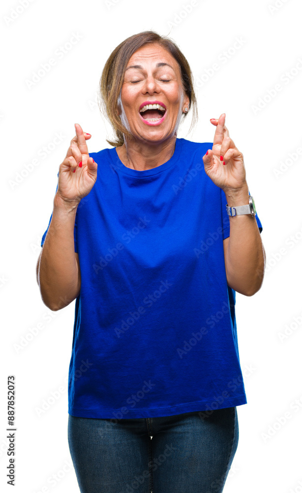 Middle age senior hispanic woman over isolated background smiling crossing fingers with hope and eyes closed. Luck and superstitious concept. Middle age senior hispanic woman over isolated background smiling crossing fingers with hope and eyes closed. Luck and superstitious concept.