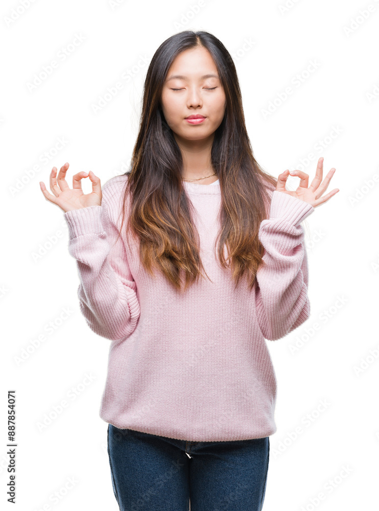 Young asian woman over isolated background relax and smiling with eyes closed doing meditation gesture with fingers. Yoga concept. Young asian woman over isolated background relax and smiling with eyes closed doing meditation gesture with fingers. Yoga concept.