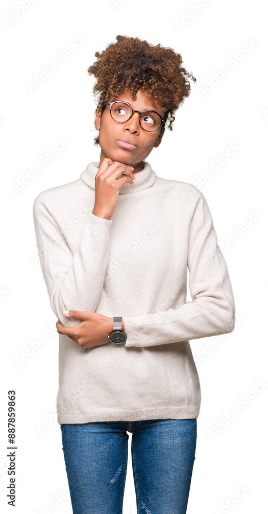 Beautiful young african american woman wearing glasses over isolated background with hand on chin thinking about question, pensive expression. Smiling with thoughtful face. Doubt concept. Beautiful young african american woman wearing glasses over isolated background with hand on chin thinking about question, pensive expression. Smiling with thoughtful face. Doubt concept.