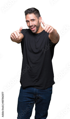 Young handsome man over isolated background approving doing positive gesture with hand, thumbs up smiling and happy for success. Looking at the camera, winner gesture.