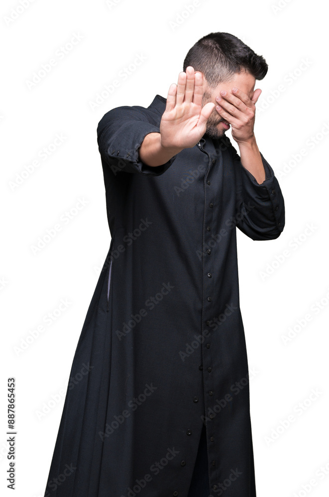 Young Christian priest over isolated background covering eyes with hands and doing stop gesture with sad and fear expression. Embarrassed and negative concept. Young Christian priest over isolated background covering eyes with hands and doing stop gesture with sad and fear expression. Embarrassed and negative concept.