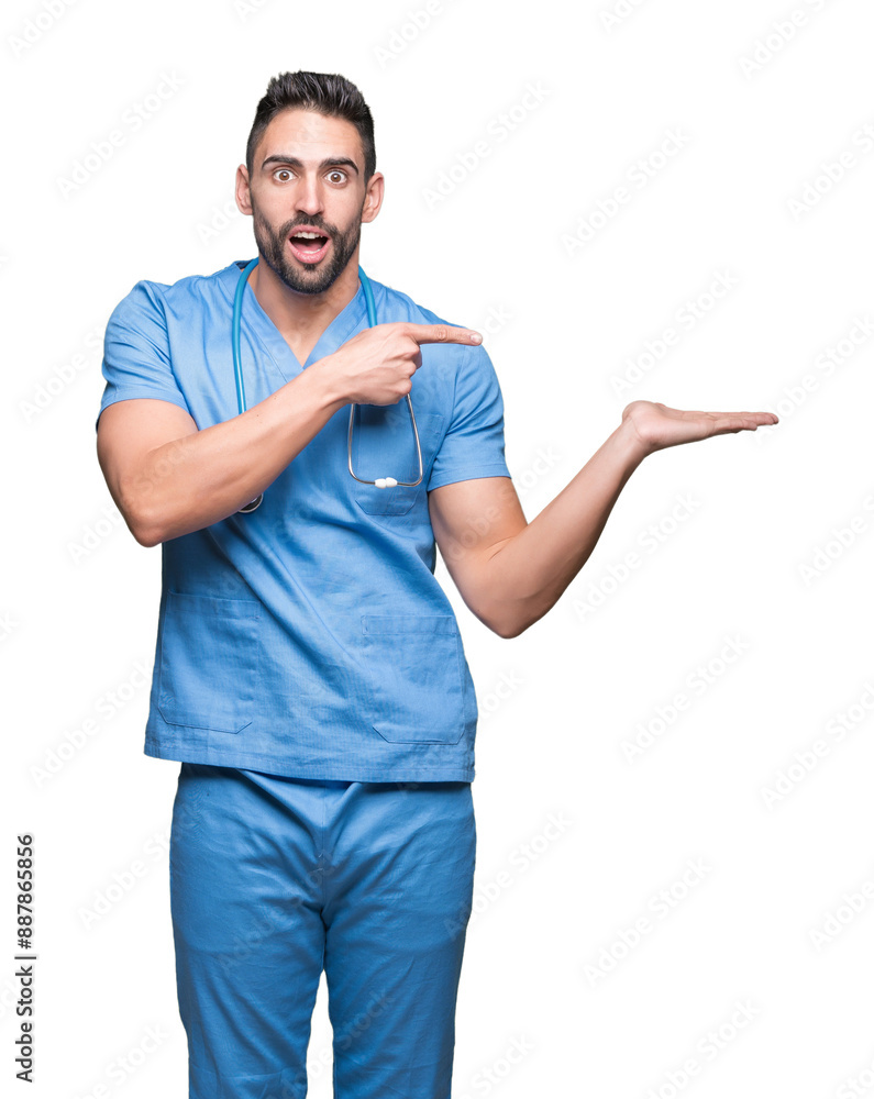 Handsome young doctor surgeon man over isolated background amazed and smiling to the camera while presenting with hand and pointing with finger. Handsome young doctor surgeon man over isolated background amazed and smiling to the camera while presenting with hand and pointing with finger.