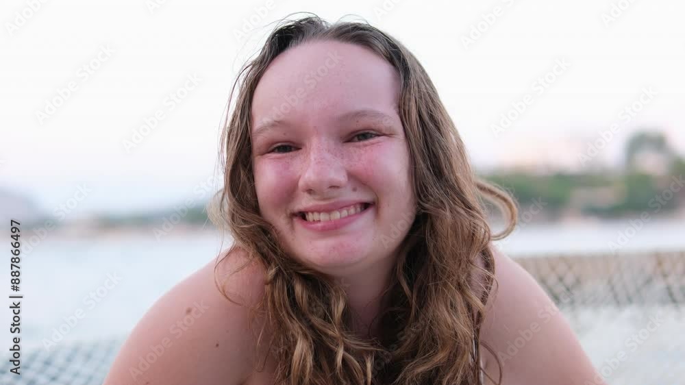 Tight smile. Relaxing on beach emotions of young girl burnt skin red cheeks wet hair. swimming summer vacation. Woman on background of lake sea river Tight smile. Relaxing on beach emotions of young girl burnt skin red cheeks wet hair. swimming summer vacation. Woman on background of lake sea river