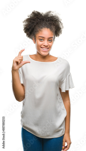 Young afro american woman over isolated background smiling and confident gesturing with hand doing size sign with fingers while looking and the camera. Measure concept.