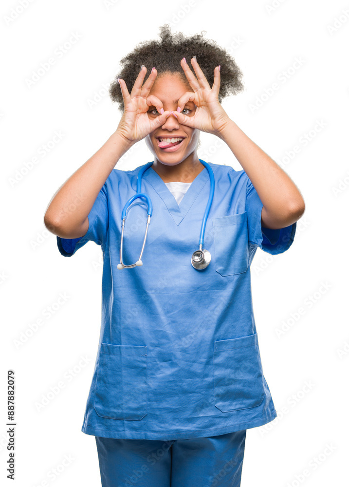 Young afro american doctor woman over isolated background doing ok gesture like binoculars sticking tongue out, eyes looking through fingers. Crazy expression. Young afro american doctor woman over isolated background doing ok gesture like binoculars sticking tongue out, eyes looking through fingers. Crazy expression.