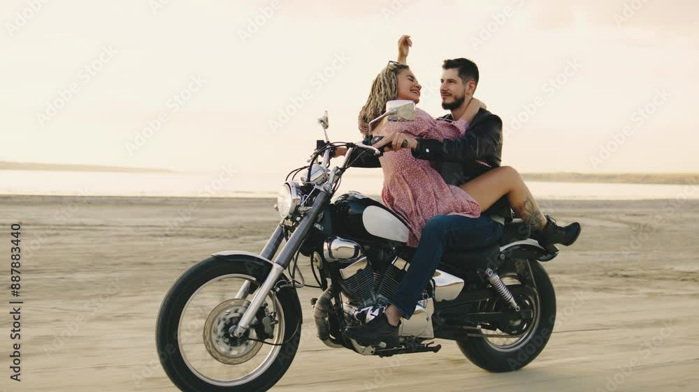 A couple enjoys a thrilling motorcycle ride at sunset on the beach, representing freedom, love, and adventure. Their journey symbolizes exploration and a happy, carefree bond A couple enjoys a thrilling motorcycle ride at sunset on the beach, representing freedom, love, and adventure. Their journey symbolizes exploration and a happy, carefree bond