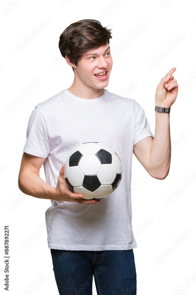 Young man holding soccer football ball over isolated background very happy pointing with hand and finger to the side Young man holding soccer football ball over isolated background very happy pointing with hand and finger to the side