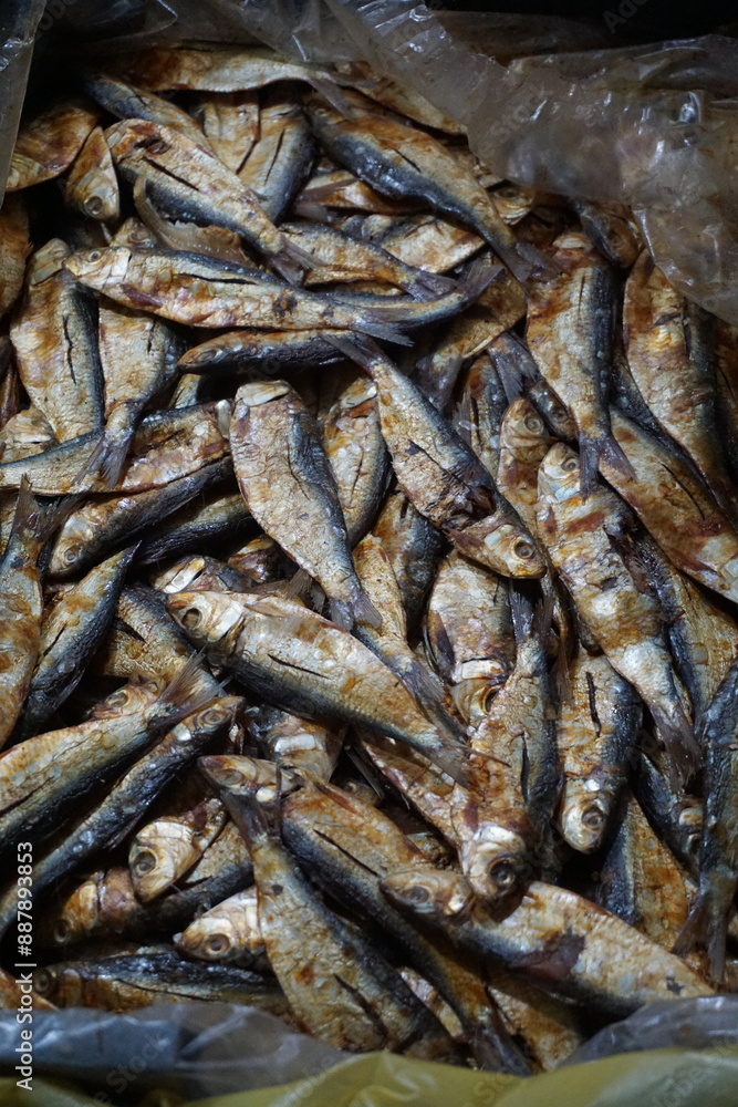 Dried sardines are displayed and being sold on a dry fish market, Salted sardines are on sale at a local Asian seafood market, Closeup shot of freshly caught dried seafood Dried sardines are displayed and being sold on a dry fish market, Salted sardines are on sale at a local Asian seafood market, Closeup shot of freshly caught dried seafood