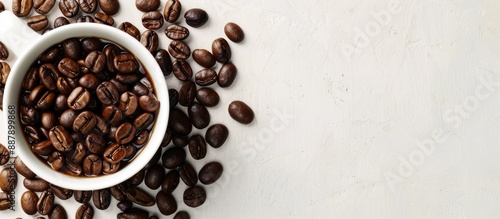 A white cup with coffee bea...