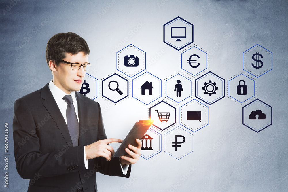 Attractive young businessman using cellphone with creative hexagonal pattern business sketch on concrete wall background. Success, technology and finance concept. Attractive young businessman using cellphone with creative hexagonal pattern business sketch on concrete wall background. Success, technology and finance concept.