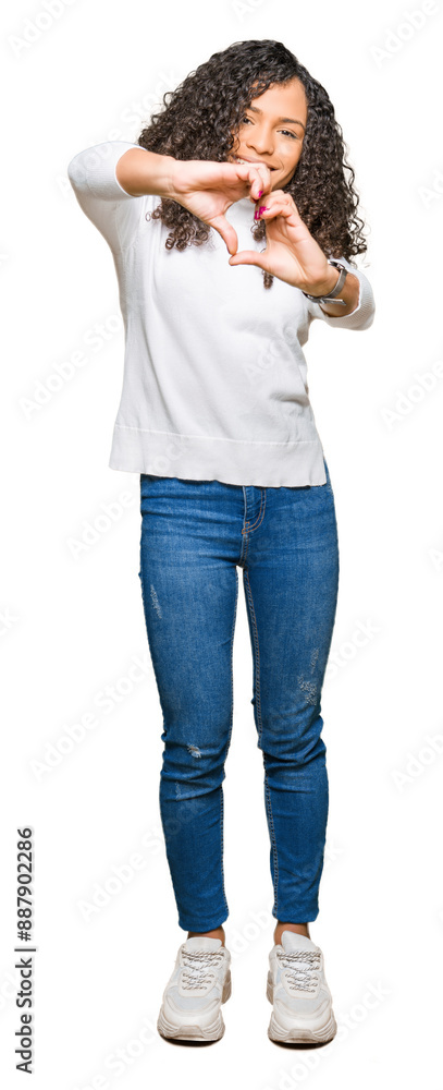 Fototapeta premium Young beautiful woman with curly hair wearing turtleneck sweater smiling in love showing heart symbol and shape with hands. Romantic concept.