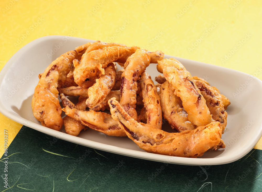 deep fried Typhoon shelter squid tentacles served in dish isolated on background side view of hong kong food deep fried Typhoon shelter squid tentacles served in dish isolated on background side view of hong kong food