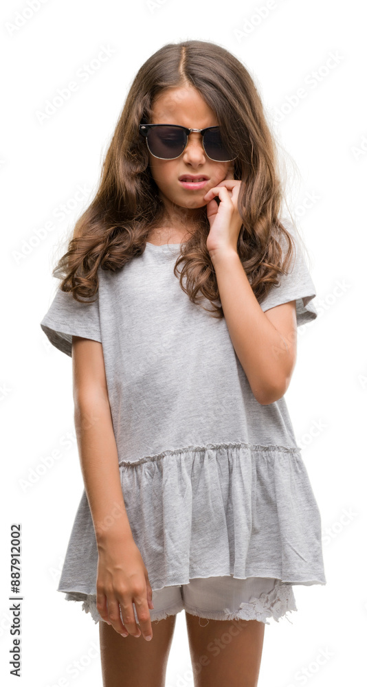 Brunette hispanic girl wearing sunglasses touching mouth with hand with painful expression because of toothache or dental illness on teeth. Dentist concept. Brunette hispanic girl wearing sunglasses touching mouth with hand with painful expression because of toothache or dental illness on teeth. Dentist concept.