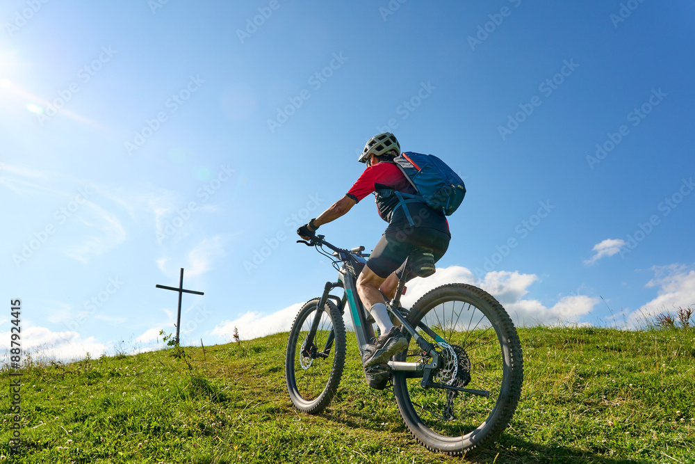 nice active senior woman riding her electric mountain bike at Mount Huendle in Oberstaufen, Allgaeu Alps , Bavaria, Germany nice active senior woman riding her electric mountain bike at Mount Huendle in Oberstaufen, Allgaeu Alps , Bavaria, Germany