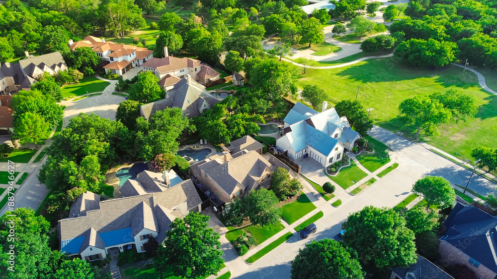 Park side upscale suburban neighborhood with cul-de-sac dead-end keyhole shape street around expensive two-story large mansion villas houses with swimming pools suburbs Dallas, Texas, aerial Park side upscale suburban neighborhood with cul-de-sac dead-end keyhole shape street around expensive two-story large mansion villas houses with swimming pools suburbs Dallas, Texas, aerial