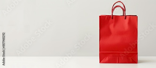 An isolated red paper shopping bag on a white background with copy space image