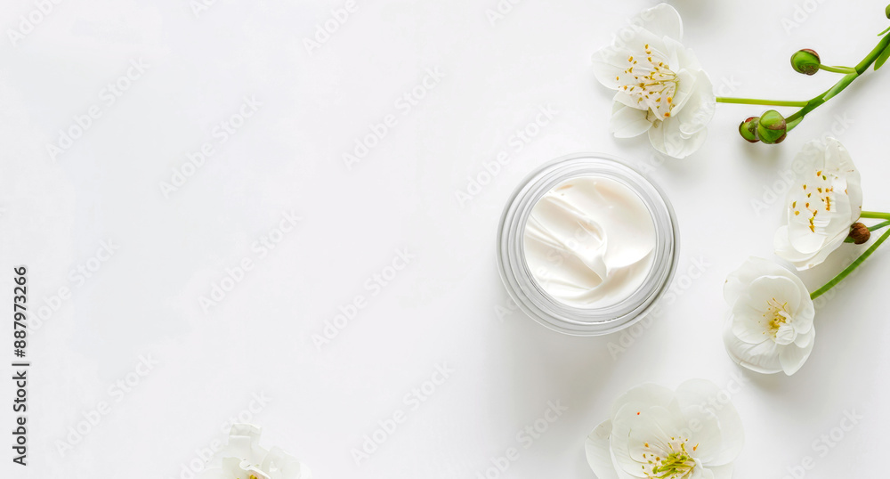 Glass jar with face cream on a white background, decorated with flowers. Top view. Copy space. Mockup Glass jar with face cream on a white background, decorated with flowers. Top view. Copy space. Mockup