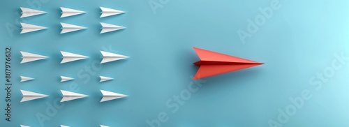 A red paper plane leads a group of white planes on a blue background banner with copy space area