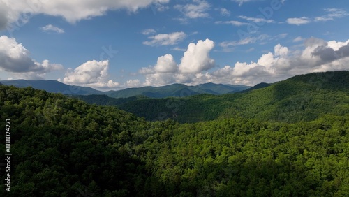 Beautiful Smoky Mountain range with green trees under blue sky and fluffy clouds