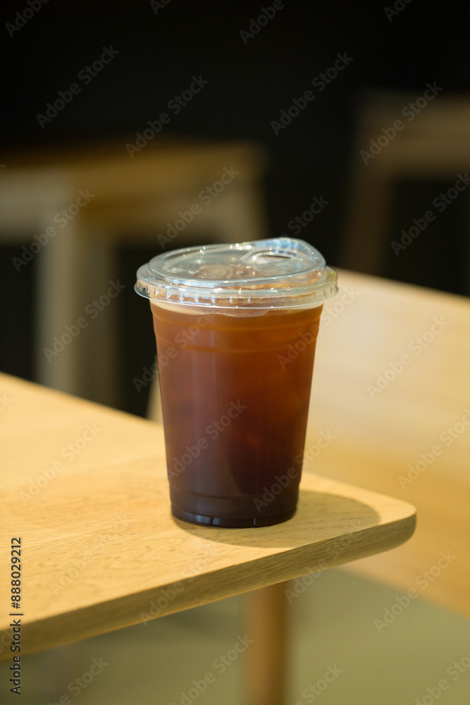 Americano in a clear cup on wood. Americano in a clear cup on wood.