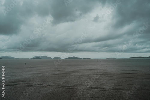 Rain storms are happening at sea in Thailand. Dark blue clouds and sea or ocean water surface with foam waves before storm, dramatic seascape.. tropical beach view with dark blue sky
