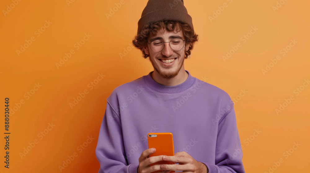 A Smartphone Symphony: A Man in Purple Sweater Finds Harmony in His Mobile Device A Smartphone Symphony: A Man in Purple Sweater Finds Harmony in His Mobile Device