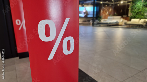 Red bright banner with the image of sales percentages on the anti-theft gate sensor in a shopping center. Red bright sale banner. Seasonal offer of discounts upon entering the store. Big red panels