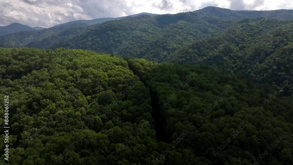 Beautiful Great Smoky Mountain landscape in North Carolina with green trees blue sky and cloud shadows on hillside Beautiful Great Smoky Mountain landscape in North Carolina with green trees blue sky and cloud shadows on hillside