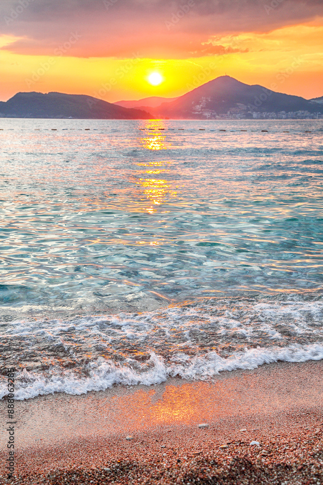 Captivating sunset view of luxury beach near islet Sveti Stefan near Budva.