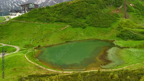 Schlappoltsee See in Bayern an Mittelstation der Fellhornbahn, Deutschland Luftaufnahme. Aerial view of Lake Schlappoldsee at the top of Mount Fellhorn and the top of the Fellhorn Mittelstation lift.  photo