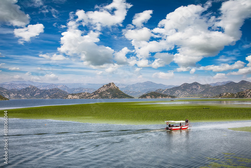 Obraz na płótnie Captivating view of Skadar lake surrounded by green mountain peaks on a sunny day. w salonie