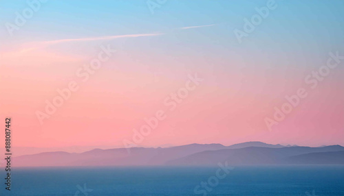 Fiery orange and pink hues paint the sky as the sun dips below the horizon  casting a warm glow on the calm ocean
