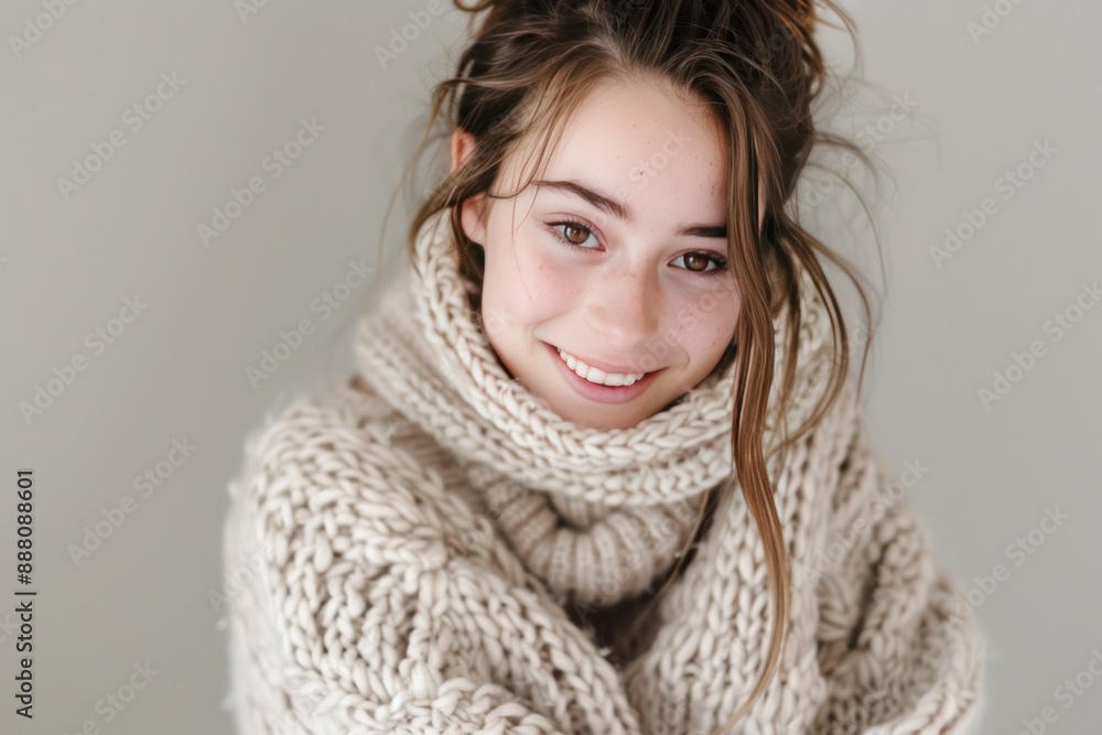 A teenage girl with tousled brown hair and a warm smile, wearing a cozy oversized knit sweater in a soft pastel shade. A teenage girl with tousled brown hair and a warm smile, wearing a cozy oversized knit sweater in a soft pastel shade.