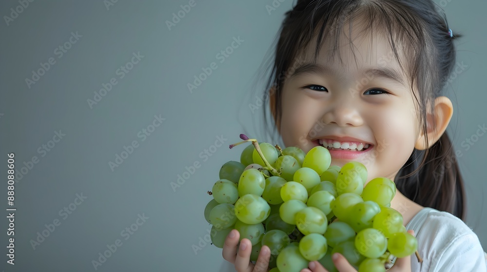 Cheerful Child Joyfully Holding Fresh Green Grapes with Bright Smile Cheerful Child Joyfully Holding Fresh Green Grapes with Bright Smile