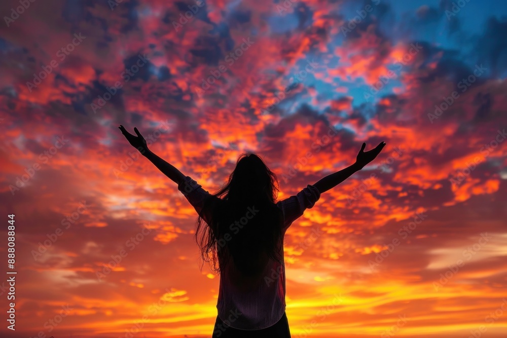 A woman lost in the beauty of a breathtaking sunset, her silhouette captured against the vibrant canvas of the sky, her arms raised in a gesture of pure bliss. A woman lost in the beauty of a breathtaking sunset, her silhouette captured against the vibrant canvas of the sky, her arms raised in a gesture of pure bliss.