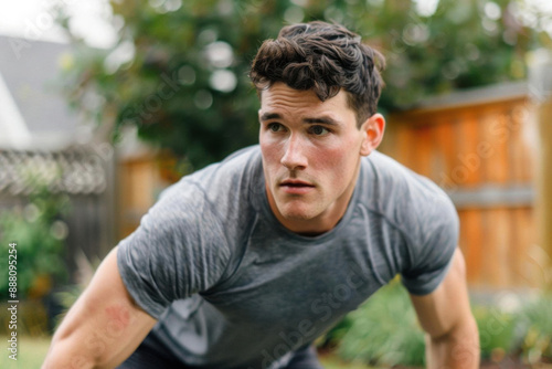 A man doing a highintensity interval training HIIT session in his backyard
