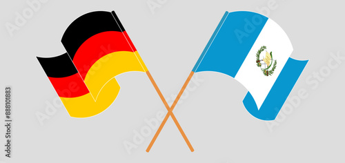 Crossed and waving flags of Germany and Republic of Guatemala