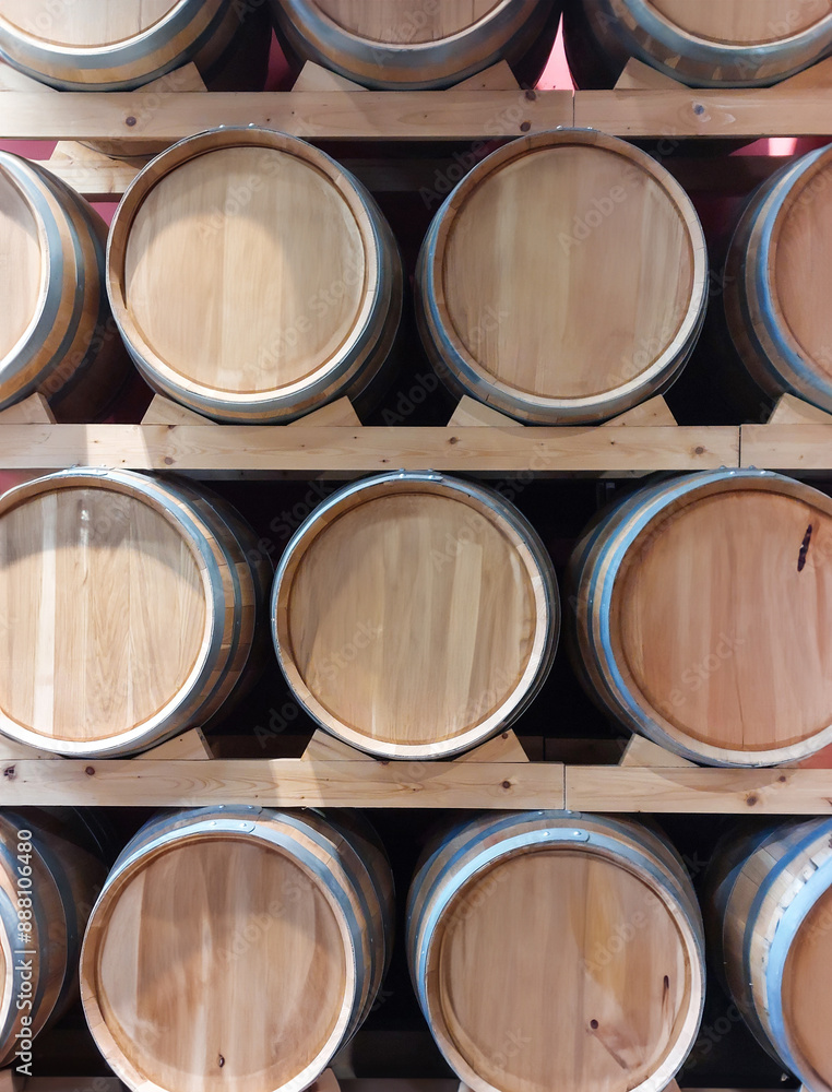 Wine cellar showing oak barrels stacked on wooden shelves Wine cellar showing oak barrels stacked on wooden shelves