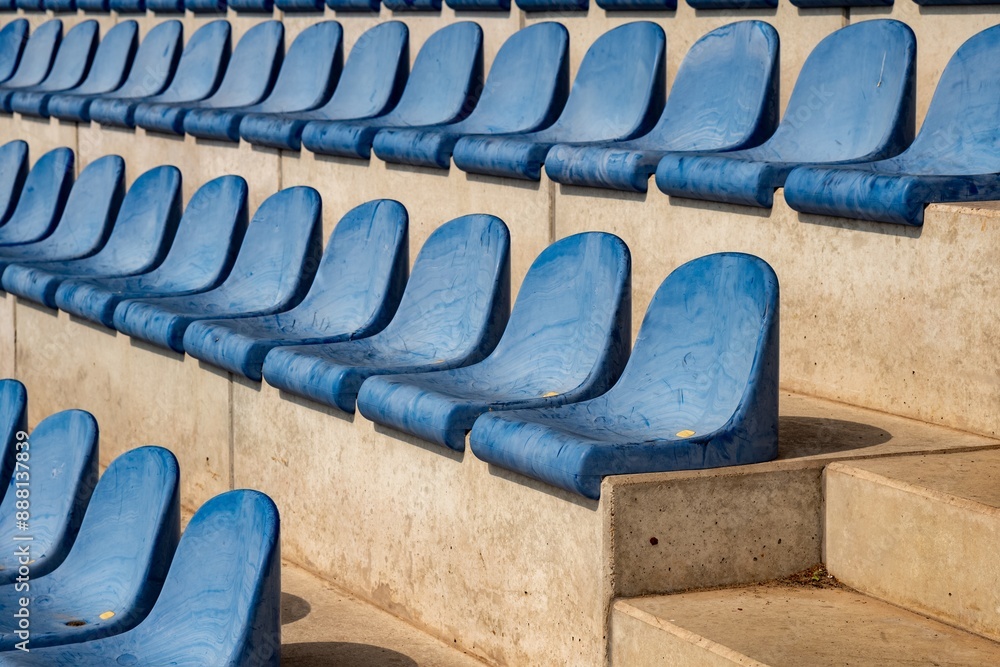 Obraz premium long rows of blue seats on a sports field stand