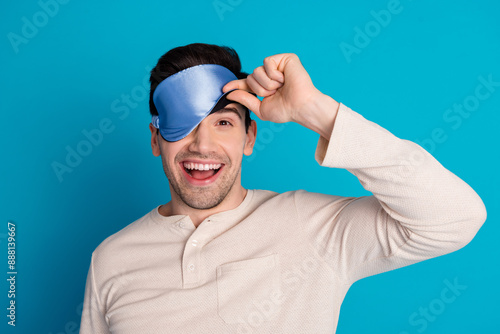 Photos Photo portrait of handsome young guy peek eyes covered mask sleep dressed sleepw