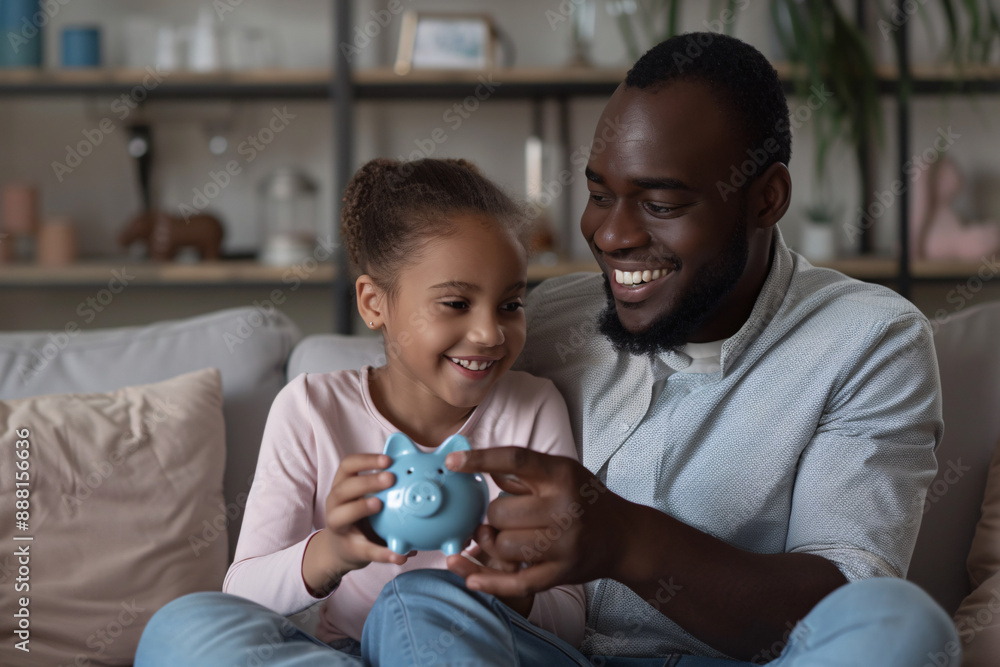 a man and a girl sitting on a couch holding a piggy bank a man and a girl sitting on a couch holding a piggy bank