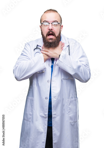 Young caucasian doctor man wearing medical white coat over isolated background shouting and suffocate because painful strangle. Health problem. Asphyxiate and suicide concept.