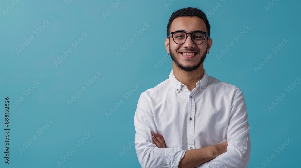 Smiling confident arab young man, male student, professional employee or programmer standing isolated on blue background. Happy handsome ethnic guy wearing shirt and glasses, Generative AI. Smiling confident arab young man, male student, professional employee or programmer standing isolated on blue background. Happy handsome ethnic guy wearing shirt and glasses, Generative AI.