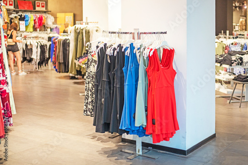 girl choosing clothes in a store with a women's department