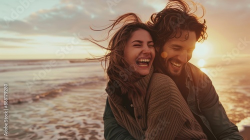 The couple laughing at sunset